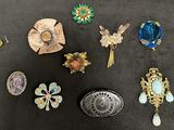 many different types of brooches on the table