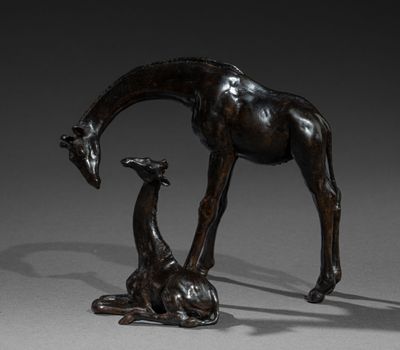 a bronze statue of a giraffe and a baby giraffe