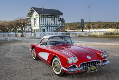 a red and white car parked in front of a building
