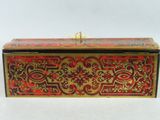 a red and gold box sitting on top of a white table
