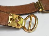a brown belt with a gold buckle on it