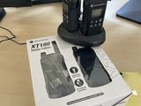 two walkie talkies sitting on top of a box
