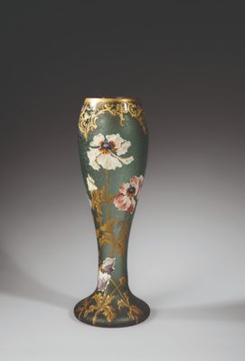 an ornate vase with a floral design on it sitting on a table