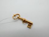 an old key with a keychain attached to it on a white surface