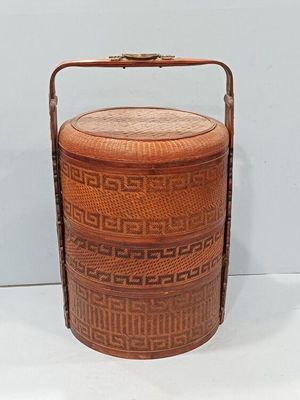 an image of a wooden basket with a handle on a white surface