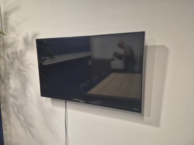a flat screen tv mounted on a wall in a living room