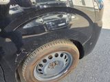 a close up of a black car with a flat tire