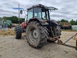 a tractor with a plow attached to it in the dirt