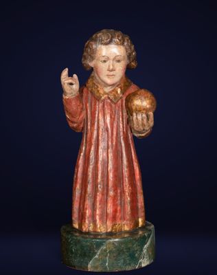 a statue of a man holding a ball on top of a marble base