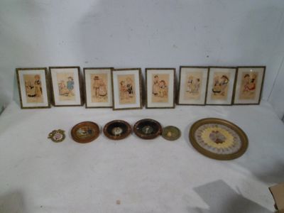a lot of framed pictures and a clock on the table