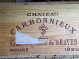 a wooden box with a sign on it that says chateau carbonneux