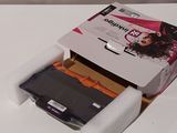 a white box that has a black and orange printer in it