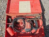 a red box with wires and wires in it on the ground