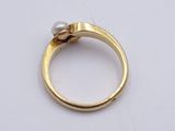 an image of a gold ring with a pearl on top of it