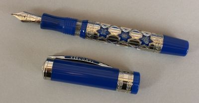 two pens sitting next to each other on a table