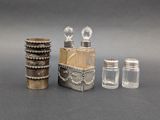 three glass jars and a bottle of perfume on a table