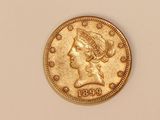 a close up of a gold coin with a woman ' s head on it