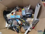 a cardboard box full of assorted items in it
