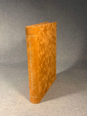 an old book sitting on top of a table next to a gray background