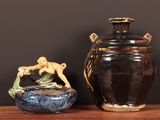 two vases that are sitting on a table