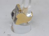 a silver and gold ring with a heart on it