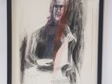 framed drawing of a man sitting in a chair with his arm resting on a pillow
