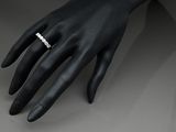 an image of a woman ' s hand with a diamond ring on it