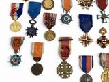 many medals and medals on display on a white surface