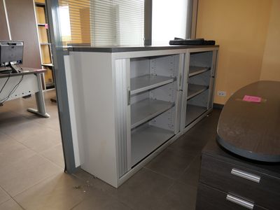 a desk with a computer on top of it in a room