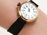 a woman ' s wrist that has a watch on it