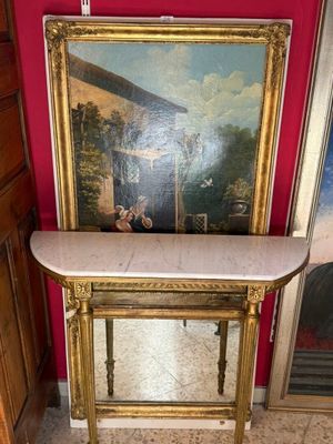 une photo d'un tableau posé sur une table dans un coin d'une pièce