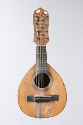 a guitar hanging from a string on the wall