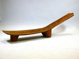 a wooden bench that is sitting on a white surface