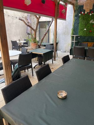 a table and chairs on a patio with a red awning