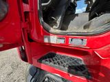 a close up of the door of a red truck