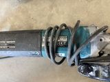 an image of a close up of a power drill on a table