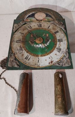 une horloge posée sur une table, entourée d'une chaîne