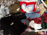 a suitcase full of clothes and a handbag on a bed