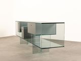 a glass table with a glass shelf in the middle of it