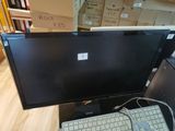 an image of a computer monitor and keyboard on a desk