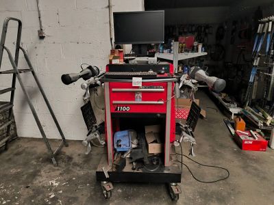 a red tool cart with a computer on top of it