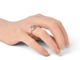 an image of a woman ' s hand with a ring on it