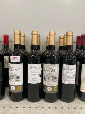 several bottles of wine are lined up on a counter