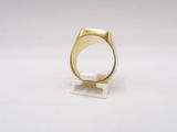 a close up of a gold ring on a white surface