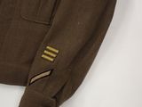 a close up of a brown jacket with gold stripes on the sleeves