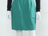 Le mannequin porte une jupe verte et un t-shirt noir.