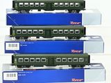 three green train cars are stacked on top of each other
