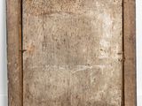 an old wooden picture frame sitting on the floor next to a white wall