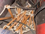 a pile of wood sticks and other items on the floor