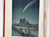 an open book with a picture of a church and a comet in the sky